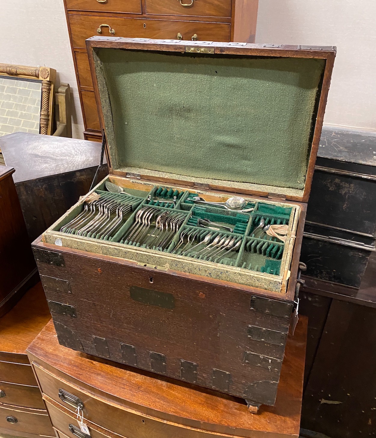 A Victorian iron bound oak silver chest with three interior trays housing assorted silver plated flatware, width 64cm, depth 41cm, height 51cm